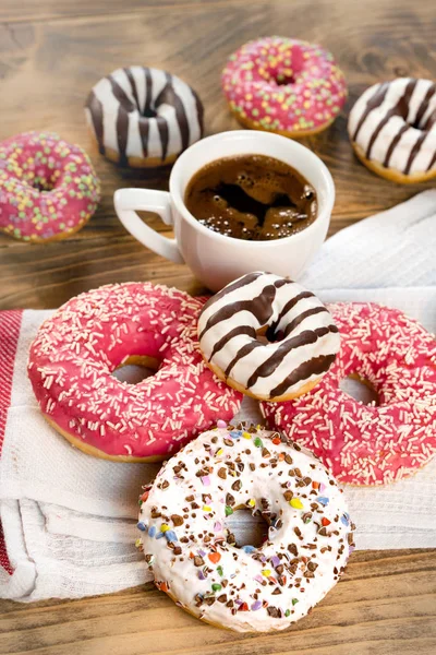 American donut and cup of coffee on table, sweet and delicious donuts