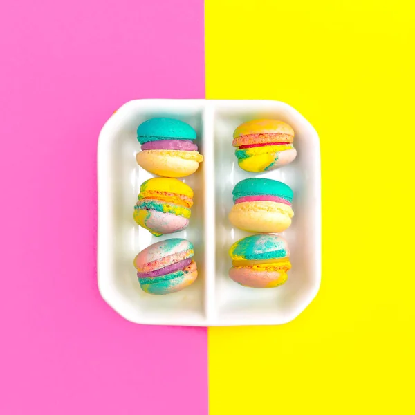 Macaroons set on colored background. Flat lay food design