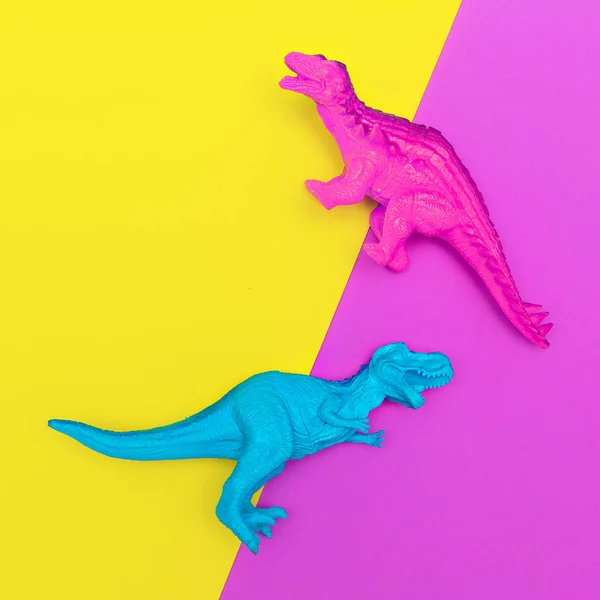 Plastic dinosaurs on a colored background. Minimal flat lay art — Stock Photo, Image