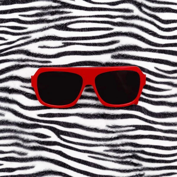 Stylish red sunglasses and zebra animal print. Safari mood — Stock Photo, Image