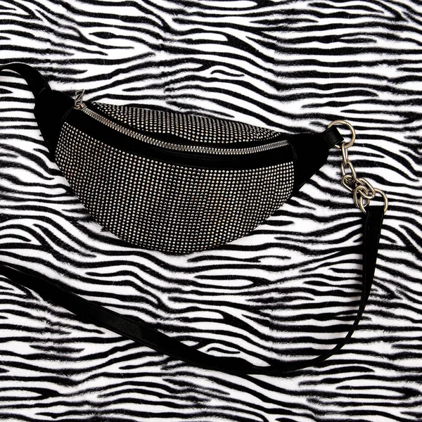 Stylish clutch bag on animal zebra print. Flat lay fashion art — Stock Photo, Image