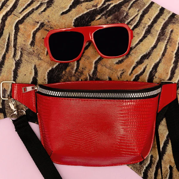 Animal print close-up and stylish red accessories. Clutch and su — Stock Photo, Image