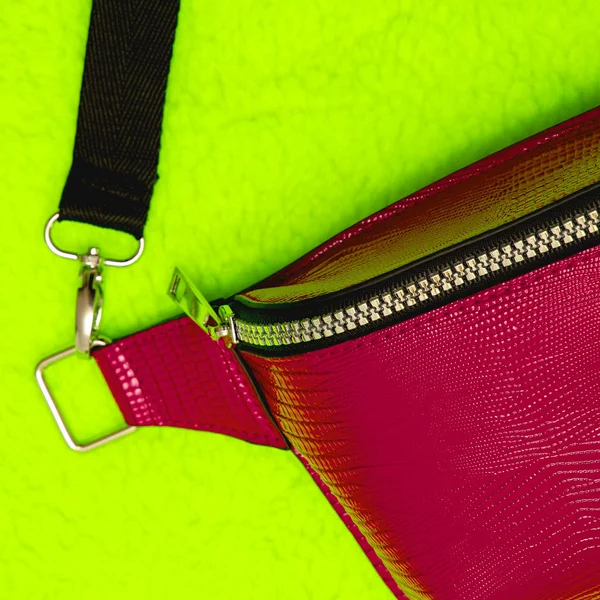 Red leather clutch bag close-up details. Fashion concept