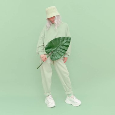 Stüdyoda poz veren hippi kız. Şehir tarzı. Hip-hop. Dansçı. Moda Taze Kıyafet. Moda nanesi tek renkli estetik renkler.