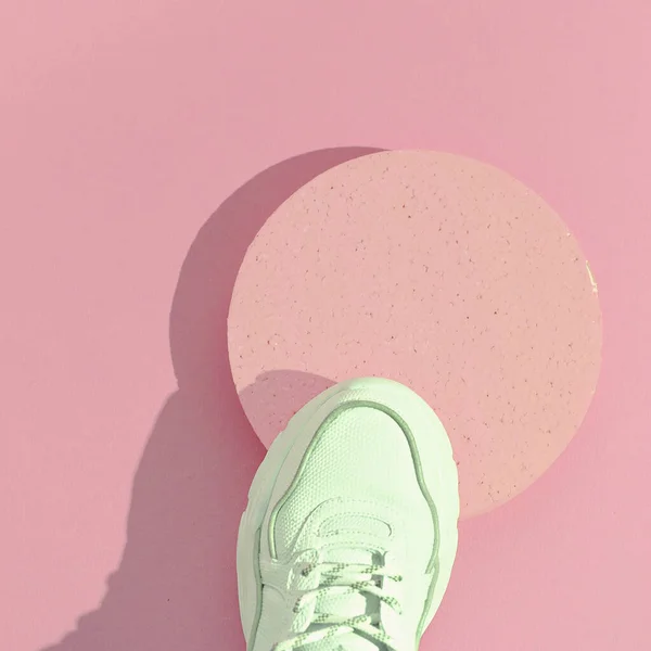 Minimal still life art. Fashion sport shoes concept. Pink colours trends. Stylish white sneakers