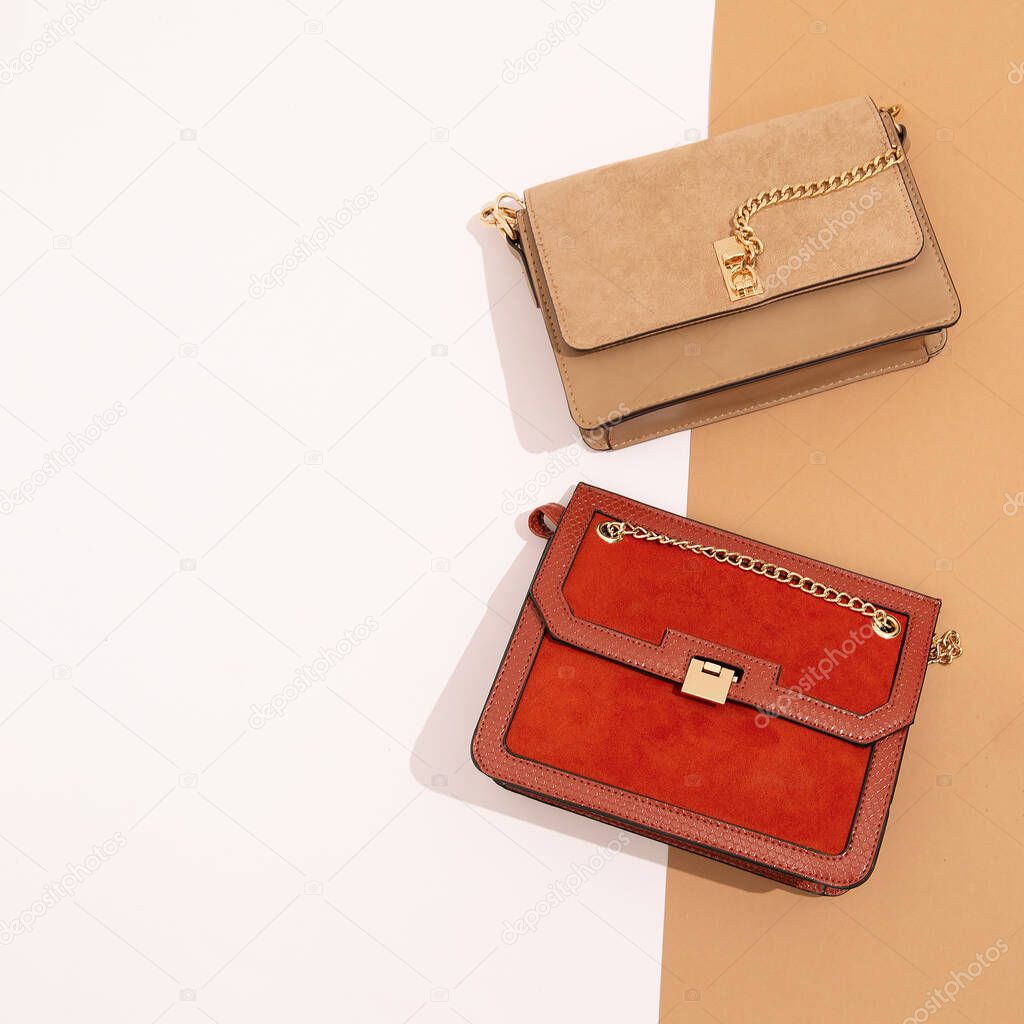 Stylish autumn accessories flat lay minimal. Clutch bags set. Fall winter fashion concept. Design colours background. Copy space
