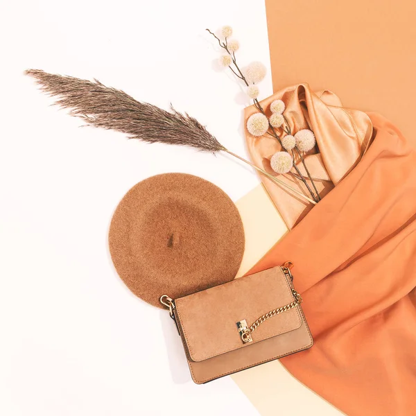 Fashion Flat lay clutch bag and accessories. Minimal fall winter decor. Stylish autumn, winter clothes shopping, sale concept, Beige colours trends