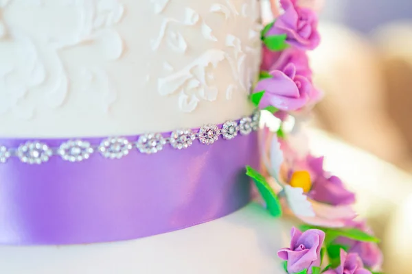 cake decoration. beautiful wedding cake with purple orchids. cake in violet tones