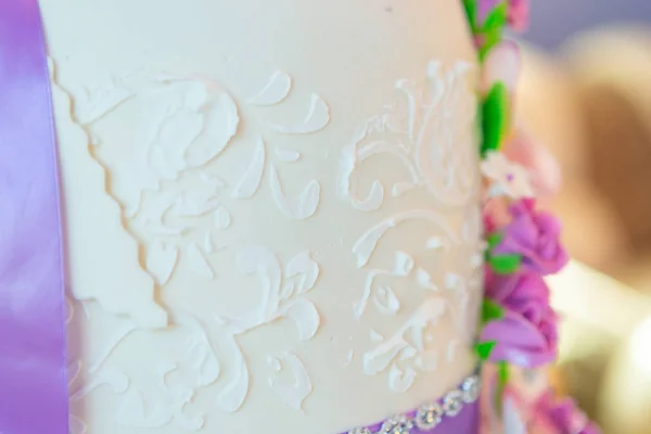 cake decoration. beautiful wedding cake with purple orchids. cake in violet tones