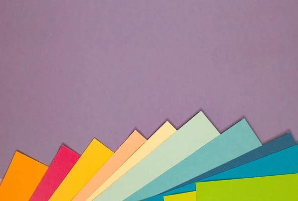 sheets of colored paper. Many colored sheets of paper are laid out in the harsh composition. background of colored paper.