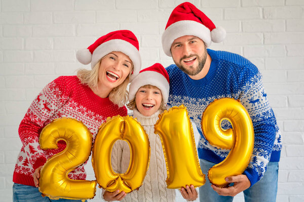 Happy family holding numbers 2019. People celebrating New Year holiday