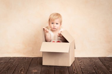 Kırmızı kalp ile mutlu bir çocuk. Komik çocuk evde oynamak. Sevgililer günü kavramı