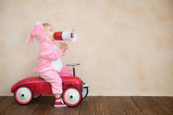 Funny Kid Wearing Easter Bunny Child Riding Toy Car Home — Stock Photo, Image