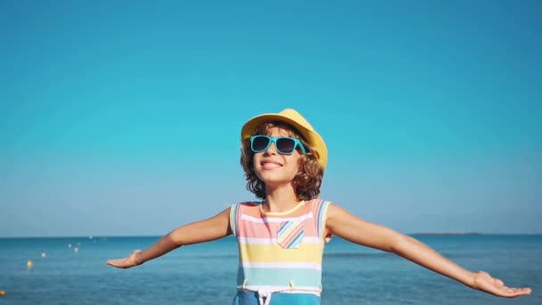 青い海と空の背景に対して開いている手で幸せな子 子供の夏休みに楽しい時を過します 自由と想像力の概念 — ストック動画