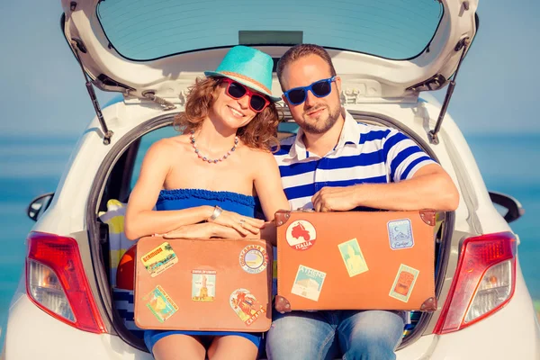 Happy couple travel by car. People having fun on the beach. Summer vacation concept