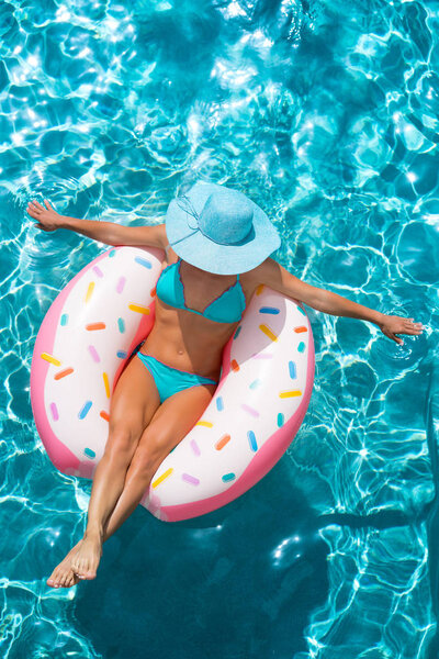 Top view portrait of woman in the swimming pool. Summer vacation concept