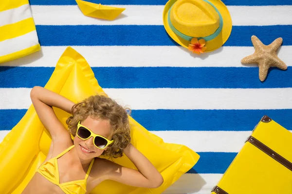 Top view portrait of child on striped beach towel — Stock Photo, Image