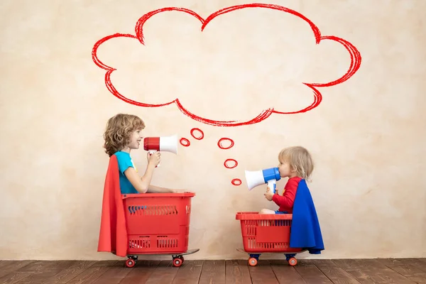 Happy children driving toy car at home — Stock Photo, Image