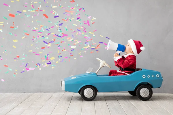 Happy child dressed Santa Claus costume playing at home — Stock Photo, Image