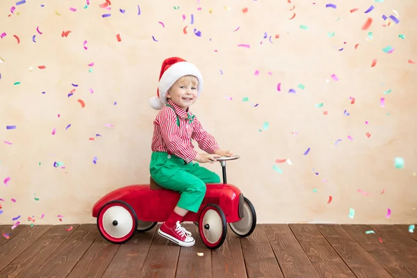 Glückliches Kind im Weihnachtsmann-Kostüm beim Spielen zu Hause — Stockfoto