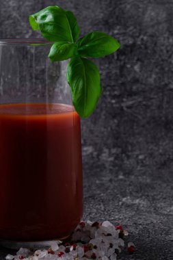 seçici odak, domates suyu, baharatlı domates suyu ve bir tutam yeşil fesleğen.