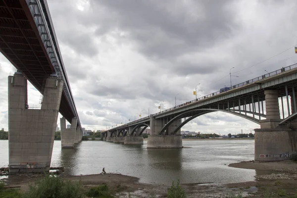 Bridges over the Ob river in Novosibirsk. The world\'s largest metro bridge and Communal bridge across Ob river in Novosibirsk, Russia
