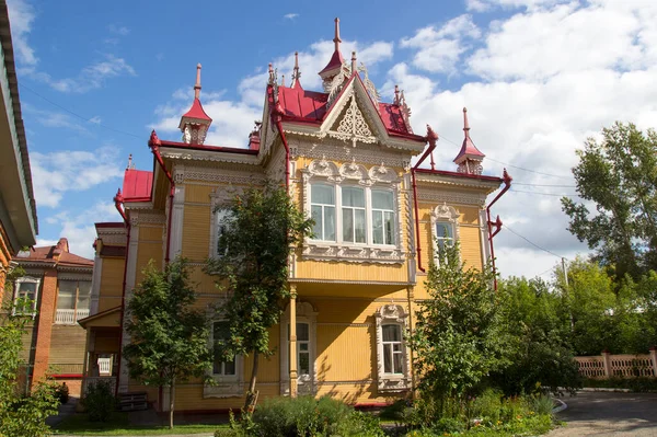 Russian style in architecture. House with firebirds, Wooden house, Tomsk, Russia. Beautiful carved elements of Russian Northern architecture