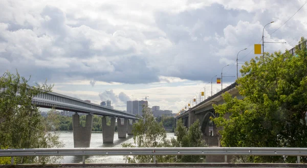 Bridges over the Ob river in Novosibirsk. The world's largest metro bridge and Communal bridge across Ob river in Novosibirsk, Russia — Stock Image Bridges River Novosibirsk World Largest Metro Bridge Communal Bridge River Royalty Free Stock Images