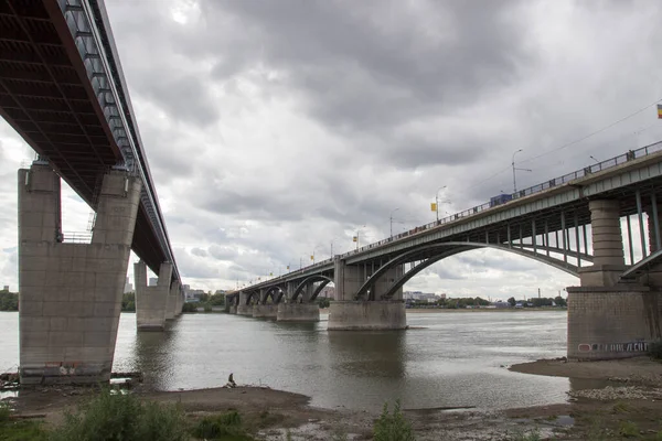Bridges over the Ob river in Novosibirsk. The world's largest metro bridge and Communal bridge across Ob river in Novosibirsk, Russia — Stock Image Bridges River Novosibirsk World Largest Metro Bridge Communal Bridge River Royalty Free Stock Photos
