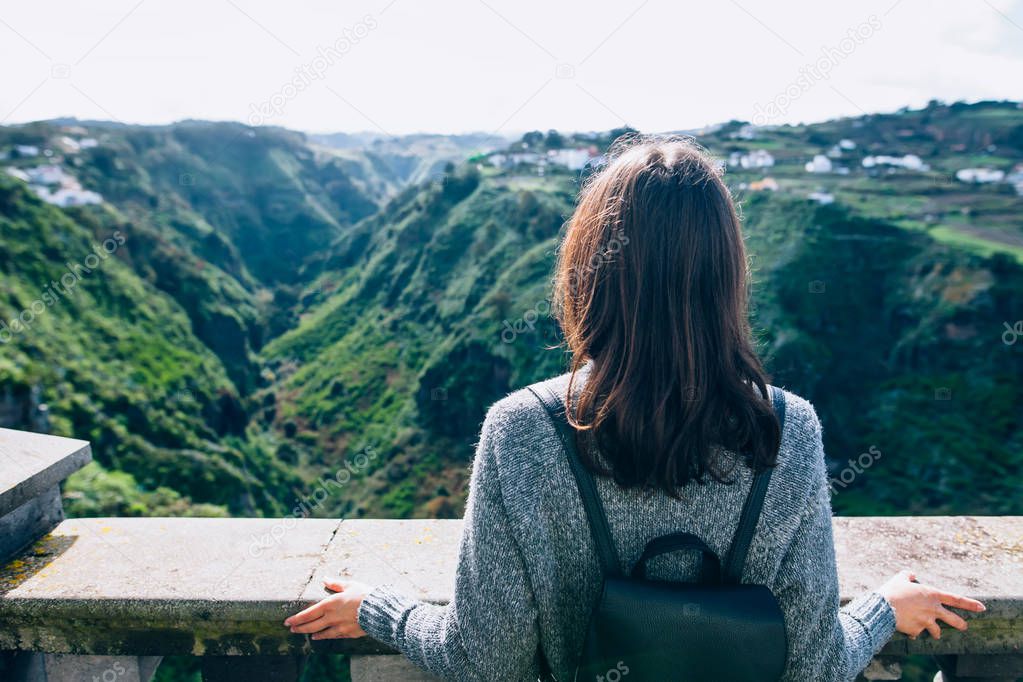 Back view of traveler woman enjoying green canyon on Gran Canaria, Canary islands, Spain