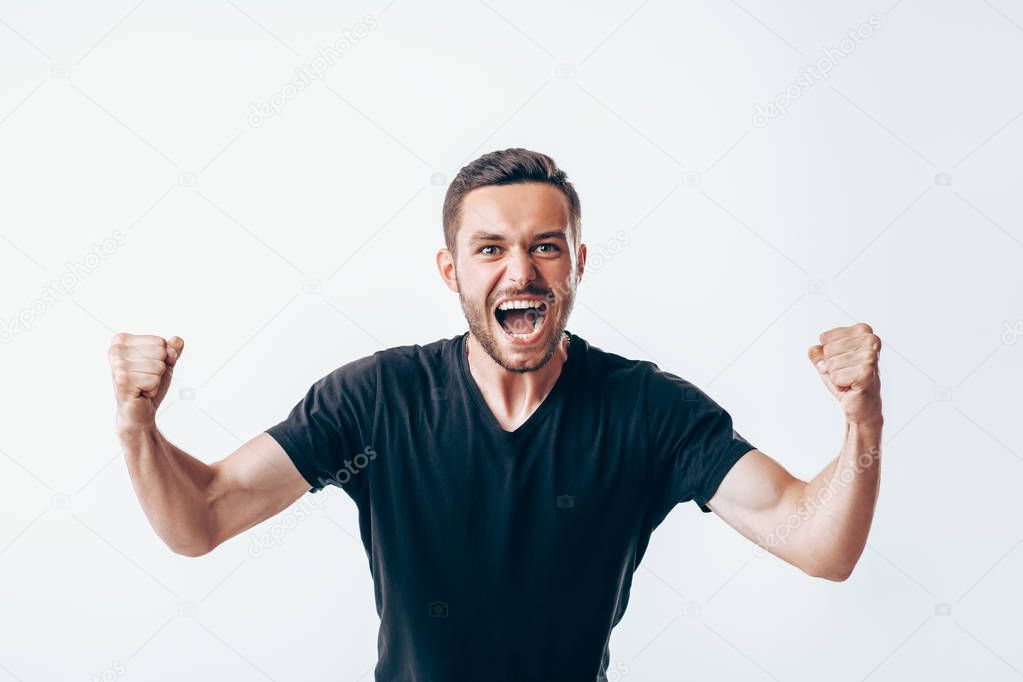 Happy winner man with fists up celebrating success
