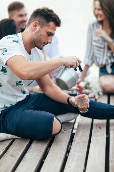 Young Man Pouring Tea Cup Picnic Sitting Wooden Pier Camping — Stock Photo, Image
