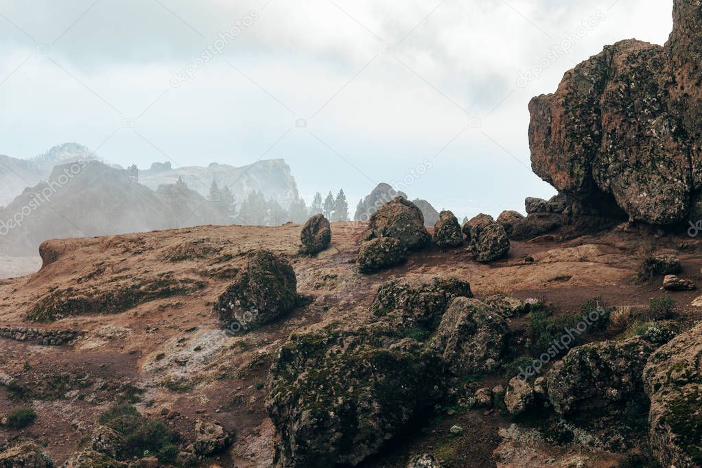 Roque Nublo mountains covered with fog in Gran Canaria, Spain. Volcanic nature 