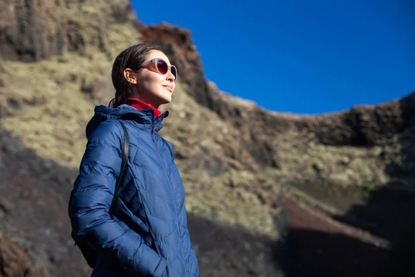 Traveler woman enjoy unique volcanic landscapes of Timanfaya National Park, Lanzarote, Canary island.