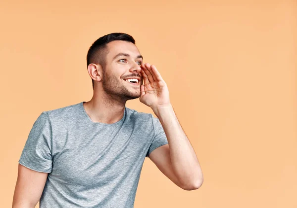 Joven Hombre Guapo Gritando Gritando Fuerte Lado Con Mano Boca —  Fotos de Stock