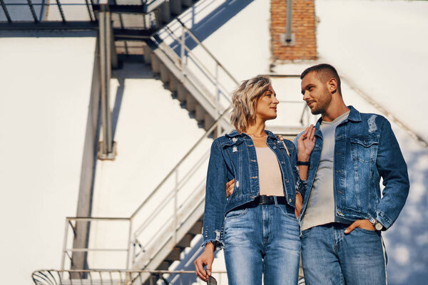 Young beautiful woman and man in jeans clothing