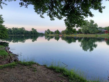Ağaçlarla çevrili güzel bir gölün geniş manzarası