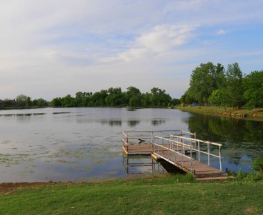 Korkulukları ile yüzen ahşap rıhtım ile bir göl görünümü