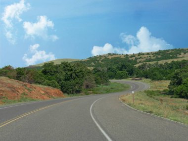 Winding road around the Wichita Mountains in Oklahoma. clipart
