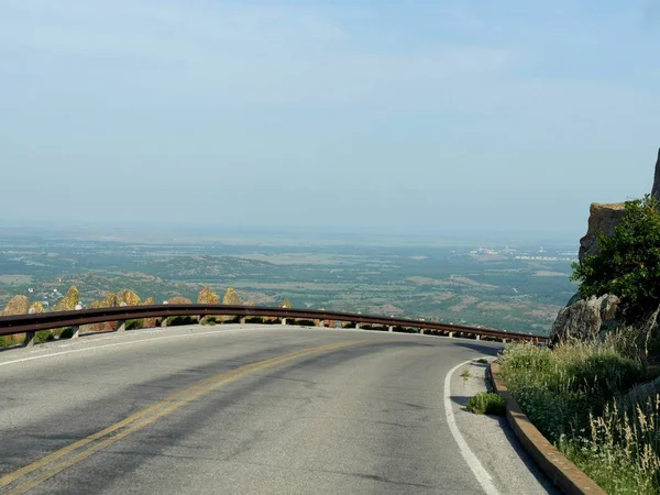 Sharp curve in the road from the peak of Mt Scott in Oklahoma, USA.