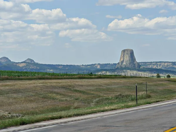 Devils Tower in Wyoming with the surrounding landscape. Devils Tower is America\'s first national monument.