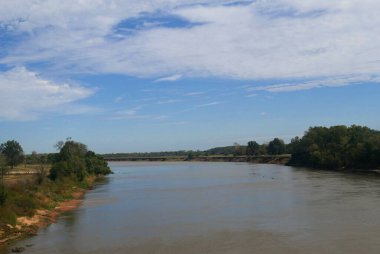 Panoramic shot of the Red River at the border of Oklahoma and Texas along Interstate 35. The Red River is the second largest river basin in the Great Plains forking to the Texas Panhandle and Oklahoma. clipart