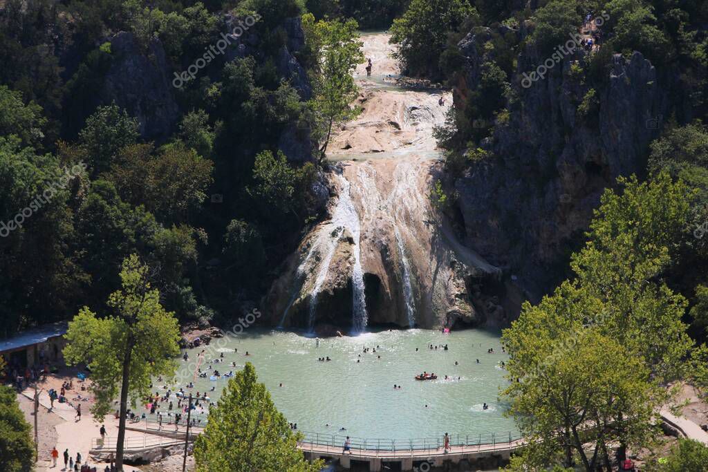 Medium wide aerial shot of Turner Falls