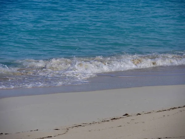 熱帯のビーチの柔らかい白い砂の中に泡立つ波 — ストック写真