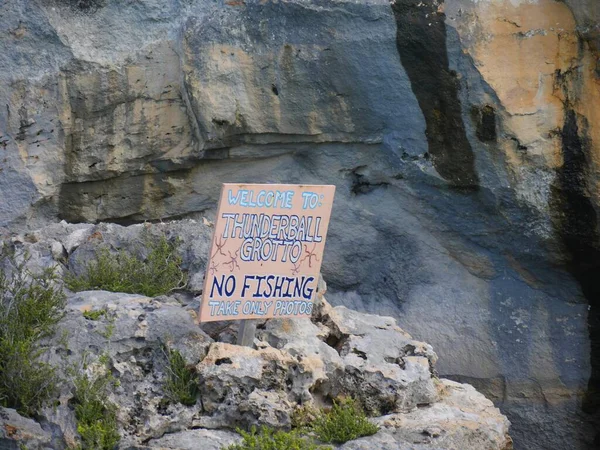 Close up of the sign at the Thunderball Grotto in the Exuma Cays, Bahamas. The location is a popular destination and has been used for filming several movies.