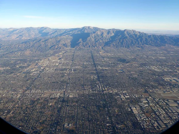 Wide aerial view of the land layout of Los Angeles, California with the distant mountains in the background