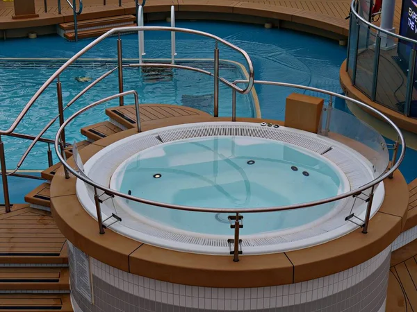 Close up of a jacuzzi tub and a swimming pool in a cruise ship