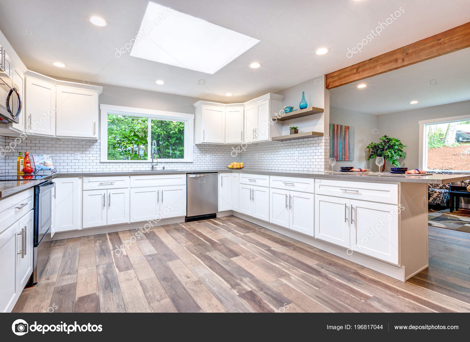 Open Concept Kitchen Skylight White Cabinets Hardwood Floor