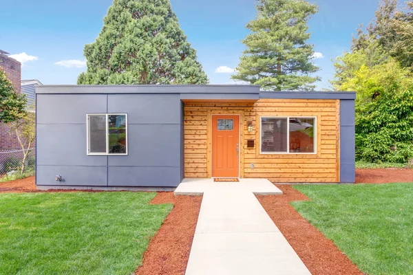 Nicely remodeled home exterior with wood siding.