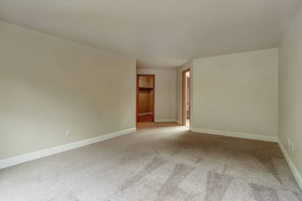 Empty bedroom of a luxury home with carpet floor.